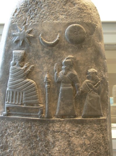 Ancient stela with Sun, Moon, and another object
